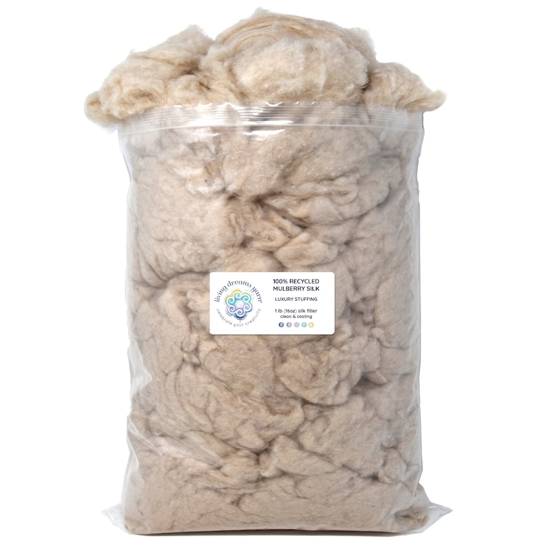 May include: A clear plastic bag filled with a large amount of light brown recycled mulberry silk fiber. The bag has a label that reads "100% Recycled Mulberry Silk Luxury Stuffing 1lb/Mooi Silk Fiber  Dream & Cooling" with social media icons.