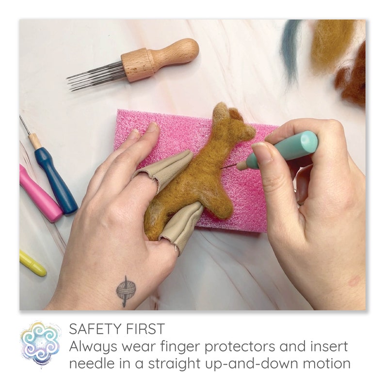 May include: A craft project in progress, featuring a felted animal being shaped with a needle tool. The image shows finger protectors, a pink foam pad, and various tools. The text in the image reads: "SAFETY FIRST. Always wear finger protectors and insert needle in a straight up-and-down motion."