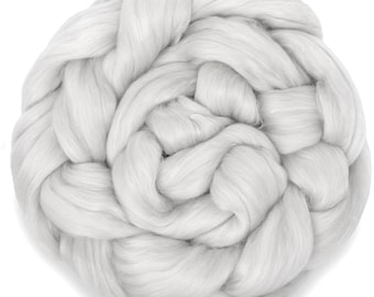 May include: A large clump of white wool fiber, perfect for spinning or felting.
