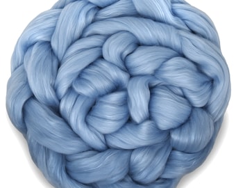 May include: A large ball of light blue fiber, resembling a fluffy cloud. The fiber is tightly woven and appears soft and delicate.