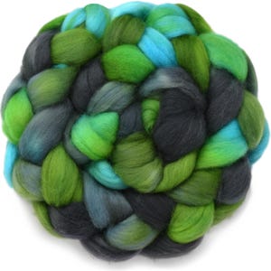 May include: A thick, braided bundle of roving wool fiber featuring a variegated color palette of bright lime green, forest green, charcoal gray, and vibrant turquoise blue, arranged in a dense, rounded, and textured circular formation.