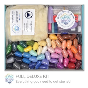 May include: A craft kit with a variety of colorful wool roving, tools, and natural wool for filling and felting. The kit includes a range of colors, from green to red, and is packaged in a box with the text "FULL DELUXE KIT".