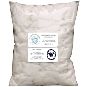 May include: A white plastic bag filled with white superwash merino wool roving. The bag has a label that reads "Superwash Merino Wool Roving 1 lb (16oz) combed top clean - safe - cruelty-free" and a second label that reads "Cruelty Free Sourced from Non-Mulesed Sheep Happy Sheep make Happy Wool".
