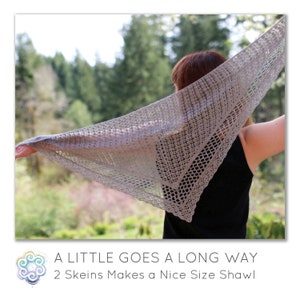 May include: A light gray, open-weave shawl is held up, showcasing its triangular shape and delicate texture. The shawl is displayed against a backdrop of green trees and a blurred background. The text at the bottom reads: "A Little Goes a Long Way, 2 Skeins Makes a Nice Size Shawl."