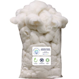 May include: A white plastic bag filled with white, fluffy, certified organic merino wool. The bag has a label that reads "Certified Organic Merino Wool 1 lb (16oz) combed top roving".