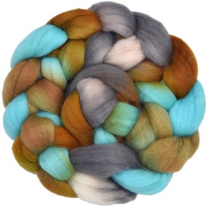 May include: A thick, braided bundle of soft wool roving featuring a multi-colored palette of bright turquoise, warm ochre, muted olive green, charcoal gray, and soft white fibers, arranged in a circular, interwoven pattern with a textured finish.