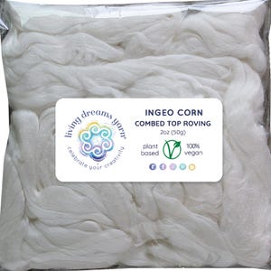 May include: A clear plastic bag filled with white combed top roving. The bag has a label with the text "INGEO CORN COMBED TOP ROVING" and "2oz (50g)". The label also includes the words "plant based" and "100% vegan".