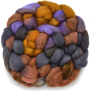 May include: A ball of yarn with a blend of purple, brown, orange, and gray colors. The yarn is arranged in a braided pattern.