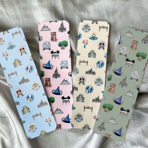 May include: Four different bookmark designs featuring various Disney World attractions. The bookmarks are printed on cardstock and feature a light blue, pink, cream, and green background.