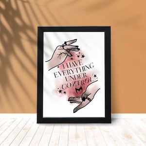 May include: A black framed print with a white background and a pink watercolor design. The design features two hands with a ring on one finger, and the text "I have everything under control" with a stylized bat symbol.