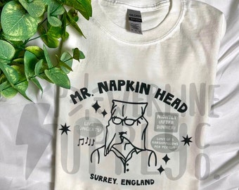 Mr. Napkin Head Concert T-Shirt | Holiday Season Y2K RomCom Tee, Gift for RomCom Movie Lover, Christmas Top, 2000s Holiday Movie