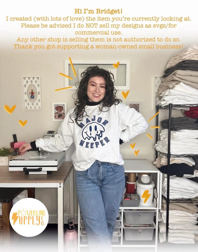 May include: A woman wearing a white sweatshirt with the text "MAJOR WEEPER" in navy blue, paired with blue jeans. The image includes a heat press machine, storage shelves, and the "POWERLINE SUPPLY CO." logo.