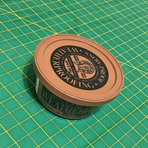 May include: A brown jar of Snow-Proof Weatherproofing with a black label and the text "Snow-Proof Weather Protection Unequaled for All Weather" and "Original Formula Since 1904".