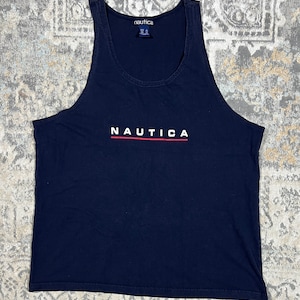 May include: A black tank top with the word "NAUTICA" printed in white with a red line underneath. The brand name "NAUTICA" is printed on the tag.