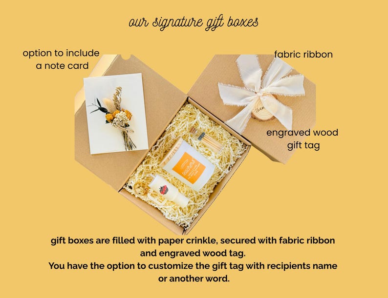 May include: Open gift boxes with paper crinkle, a note card with dried flowers, and small products. The boxes are secured with fabric ribbon and an engraved wood gift tag. Text reads "our signature gift boxes".