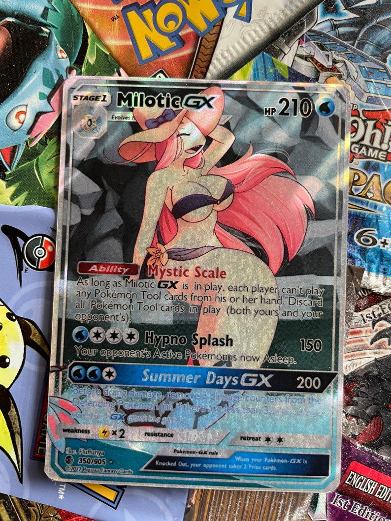 May include: A holographic Pokemon trading card featuring Milotic GX, a pink and blue water-type Pokemon with a large, flowing tail. The card has a blue background with white text and stars. The card's text includes the Pokemon's name, HP, abilities, and attacks. The card is in excellent condition.