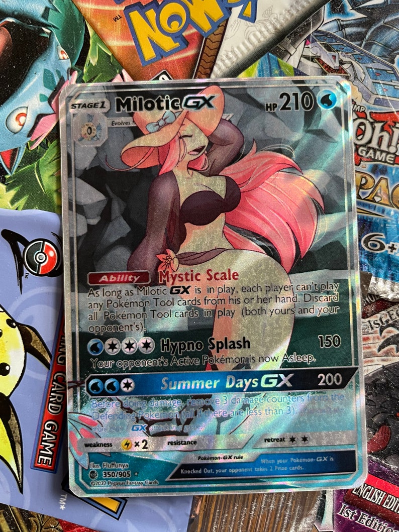 May include: A holographic Pokemon trading card featuring Milotic GX, a pink and blue water-type Pokemon with a large, flowing tail. The card has a blue background with white text and stars. The card's text includes the Pokemon's name, HP, abilities, and attacks. The card is in excellent condition.