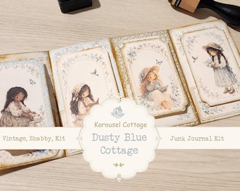 May include: A junk journal kit featuring four rectangular cards with illustrations of children in hats and floral accents. The text reads Karousel Cottage Dusty Blue Cottage Vintage, Shabby, Kit Junk Journal Kit. The cards have gold edges.