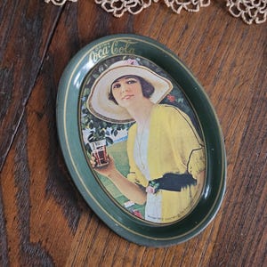 Vintage Coca-Cola Tip Tray, Small 6" Green Oval Tin Litho Coke Tray, 1970s Reproduction of Coca-Cola Girl Advertisement from 1920, Barware