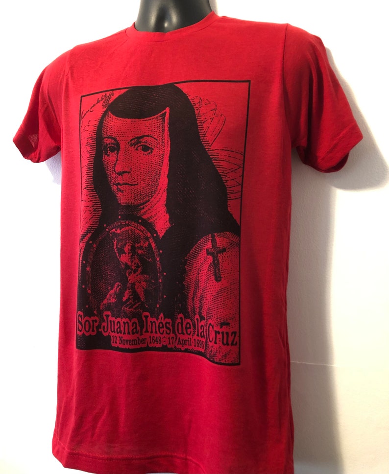 May include: Red t-shirt with a black and white image of Sor Juana In&eacute;s de la Cruz, a Mexican poet and nun. The image includes the text "Sor Juana In&eacute;s de la Cruz 12 November 1648 - 17 April 1695".