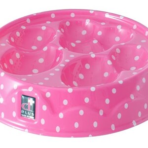 Puede incluir: Taz&oacute;n de pl&aacute;stico rosa para mascotas con lunares blancos y cuatro secciones de alimentaci&oacute;n separadas. El taz&oacute;n tiene un borde elevado y el texto "di PLUS Made in EU" en la parte inferior.
