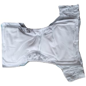 May include: White cloth nappy with adjustable poppers and a white absorbent insert. The nappy is made of soft, breathable fabric and is designed for comfortable wear.