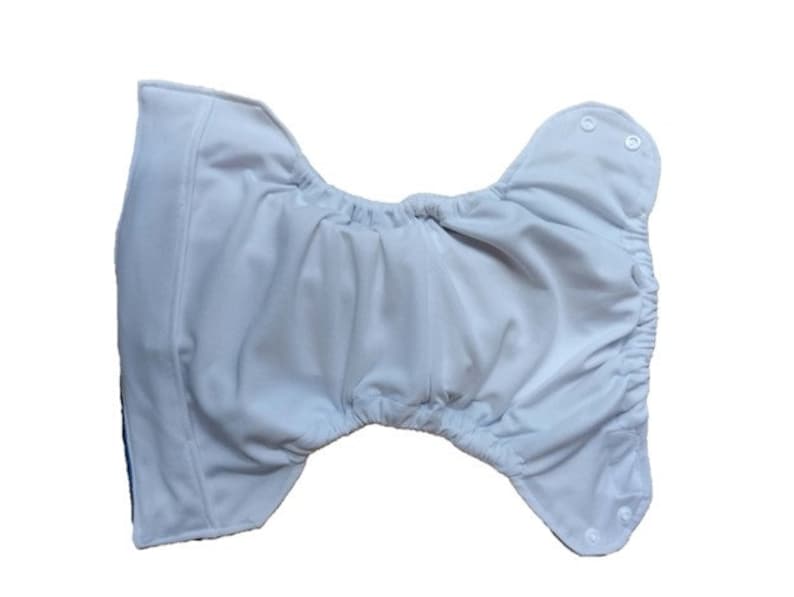 May include: White cloth diaper with adjustable snaps and a white elastic waistband.