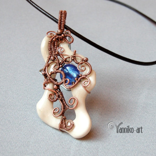 Unique wire wrapped bone pendant decorated with blue dichroic glass bead