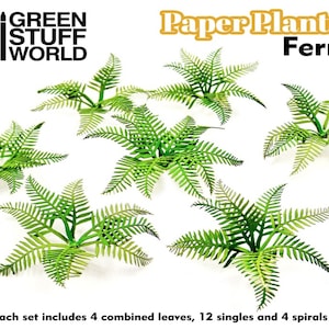 以下が含まれることがあります： 緑の葉を持つ紙製のシダ植物6個のセット。植物は白い背景に円形に配置されています。画像の上部にはオレンジ色と黒色の「Paper Plants Fern」というテキストが書かれています。画像の左上には黒色の「GREEN STUFF WORLD」というテキストが書かれています。画像の下部には黒色の「*Each set includes 4 combined leaves, 12 singles and 4 spirals」というテキストが書かれています。