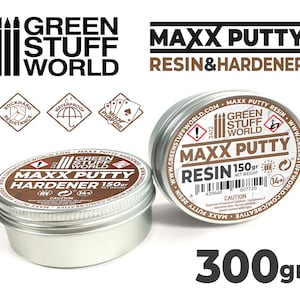 May include: Two silver tins of Green Stuff World Maxx Putty resin and hardener. The resin tin is labeled "Maxx Putty Resin 150gr" and the hardener tin is labeled "Maxx Putty Hardener 150gr". Both tins have a warning label and a 14+ age recommendation.