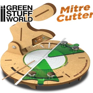 May include: A wooden mitre cutter with a green protractor and a white ruler. The cutter is labelled "Mitre Cutter" and "Green Stuff World".