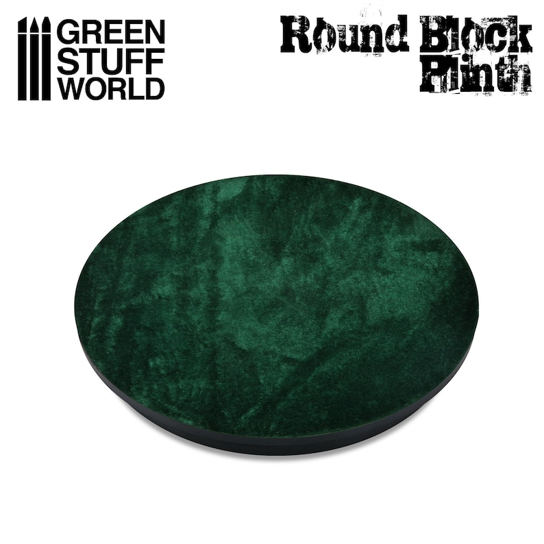 May include: A round, dark green velvet-covered display base with a black edge. The text "GREEN STUFF WORLD" and "Round Block Plinth" are printed on the top of the image. This product is designed for displaying miniatures and models.