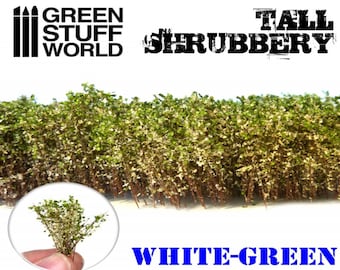 May include: A close-up of a model train landscape with a row of tall, white-green shrubbery. The shrubbery is made of a fine, textured material and is perfect for adding realism to a model train layout. The text "TALL SHRUBBERY" is visible in the image.