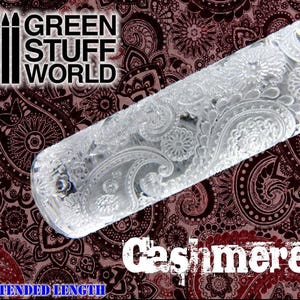 May include: A clear acrylic rolling pin with an intricate paisley pattern. The rolling pin is extended length and has the words "GREEN STUFF WORLD" and "Cashmere" printed on the image.