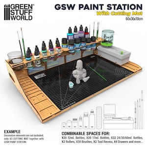 May include: A wooden GSW Paint Station with a cutting mat, measuring 60 x 36 x 10cm. It has shelves for paint bottles, a brush holder, and a cutting surface. The station includes the text "GSW PAINT STATION" and "With Cutting Mat".