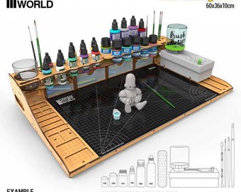 May include: A wooden GSW Paint Station with a cutting mat, measuring 23.6 x 14.2 x 3.9 inches. It features multiple shelves for paint bottles, a brush holder, and a cutting surface. The station includes the text "GSW PAINT STATION" and "With Cutting Mat".