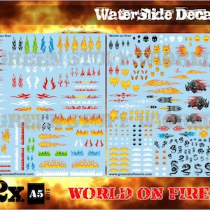 May include: Two sheets of waterslide decals featuring a variety of flames, skulls, and other designs. The decals are printed on a white background and are labeled "World on Fire!" The sheets are 2x A5 size.