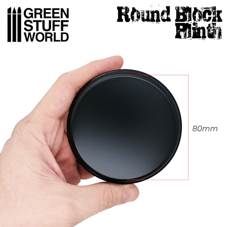 May include: A black, round product base, 80mm in diameter, held in a hand. The product is from Green Stuff World and is labeled "Round Block Plinth".