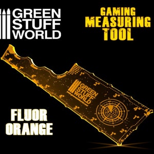 May include: A yellow plastic ruler with a black and white logo for Green Stuff World. The ruler has markings in inches and centimeters. The ruler is labeled "Gaming Measuring Tool" and "Fluor Orange".