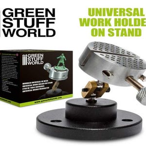 May include: A silver universal work holder on a black stand. The holder has a round base with a grid pattern and a screw for adjusting the height. The stand has a wide base for stability. The product is labeled "Green Stuff World" and "Universal Work Holder on Stand".