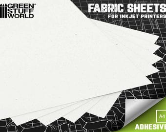 Könnte beinhalten: Ein Stapel weißer Stoffblätter für Tintenstrahldrucker. Die Blätter sind im Format A4 und haben eine Kleberückseite. Die Blätter sind mit "FABRIC SHEETS FOR INKJET PRINTERS" und "ADHESIVE" beschriftet.