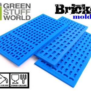 May include: Three blue silicone molds for making bricks. The molds are stacked on top of each other. The molds are labeled "Bricks mold" and "Green Stuff World".