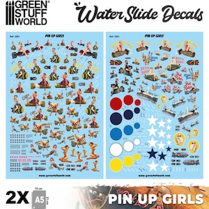 May include: Two sheets of water slide decals featuring pin-up girls in various poses. The decals are printed on a white background with blue, red, yellow, and black accents. The decals are 15 cm by 21 cm and are labelled "Pin Up Girls".