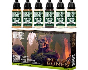Könnte beinhalten: Sechs 17 ml Flaschen Acrylfarbe für Modellieren und Miniaturen. Die Flaschen sind mit dem Green Stuff World Logo und dem Farbnamen beschriftet. Die Farben sind Sonnengebleichtes Knochen, Schnellsandbraun, Elfenbeinstoßzahn, Versengtes Holz, Fangweiß und Pergament. Das Set ist in einer Schachtel mit einer Schädel- und Knochenillustration und dem Text "Skeleton Bones" verpackt.