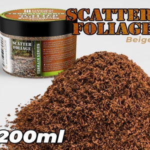 May include: A 200ml jar of beige scatter foliage for model railroading and miniature landscaping. The jar has a label that reads "Scatter Foliage Terrain Series".