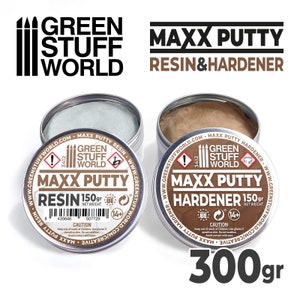 May include: Two metal containers of Maxx Putty resin and hardener, each labeled with the Green Stuff World logo and a warning sign. The resin container is silver and the hardener container is brown. The containers are labeled with the text "Maxx Putty Resin" and "Maxx Putty Hardener" and the net weight of 150 grams. The containers are labeled with a caution sign and a 14+ age recommendation. The containers are labeled with the text "www.greenstuffworld.com/creative". The containers are labeled with the text "300gr".