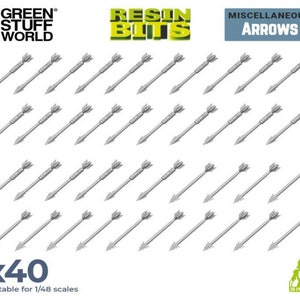 May include: A set of 40 grey plastic arrows, suitable for 1/48 scale models. The arrows are arranged in four rows of ten, with the points facing the right. The image includes the text "RESIN BITS", "MISCELLANEOUS ARROWS", and "x40".
