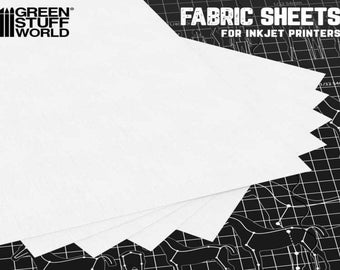 Könnte beinhalten: Ein Stapel weißer Stoffblätter für Tintenstrahldrucker. Die Blätter liegen auf einem schwarz-weißen Gitterhintergrund mit dem Text "FABRIC SHEETS FOR INKJET PRINTERS".