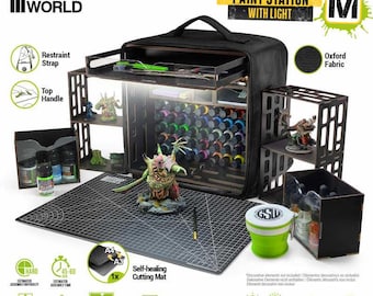 May include: Black portable paint station with light, featuring a top handle and restraint strap. Includes a self-healing cutting mat, collapsible cup, and multiple drawers. Dimensions are 11.8x11.8x7 inches. The station has 10 brightness levels and holds 50 bottles.