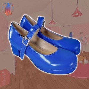 May include: A pair of blue platform shoes with a buckle strap. The shoes have a chunky heel and a rounded toe.